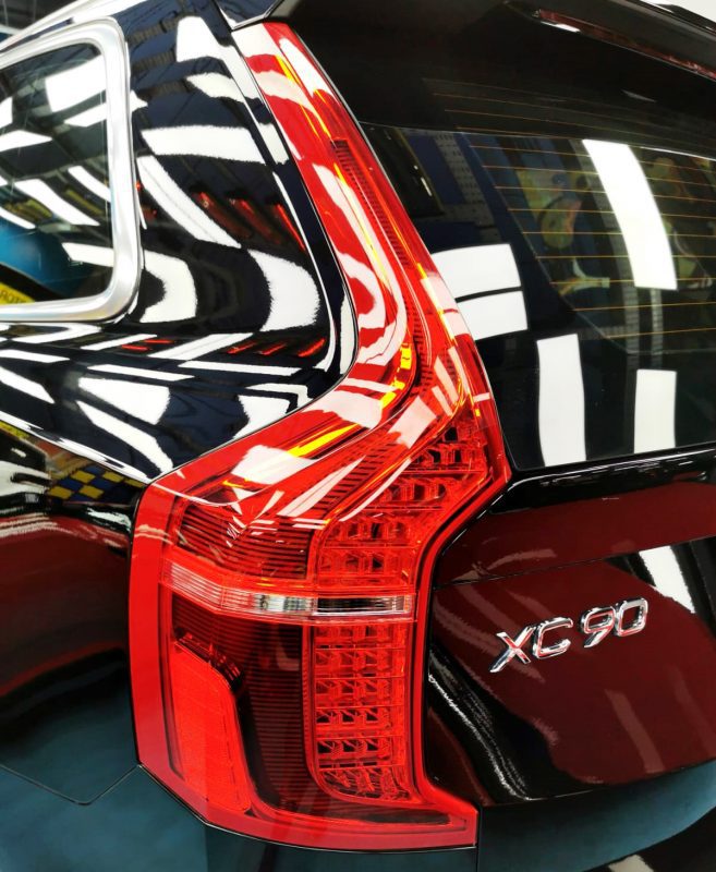The coated bonnet of the Volvo XC90 under workshop lighting.