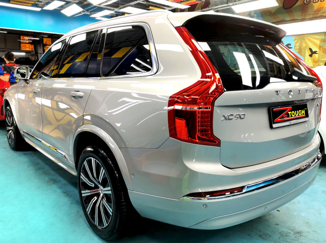 Coated bonnet of the Volvo XC90 under workshop lighting.