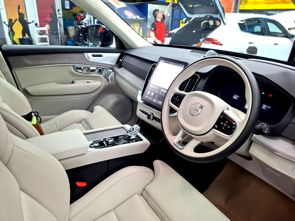 Cream leather seats and steering wheel inside the Volvo XC90.