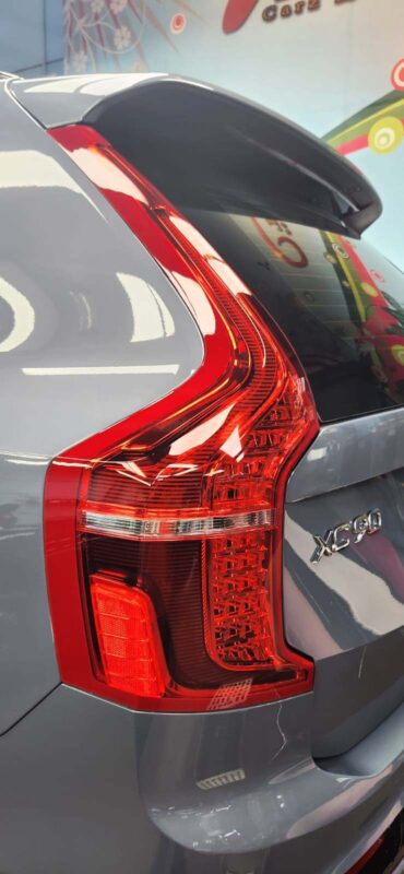 The coated bonnet of the Volvo XC90 under workshop lighting.