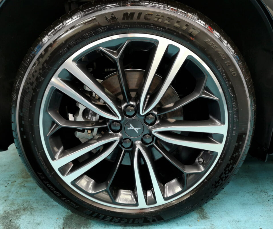 The coated bonnet of the XPeng G6 under workshop lighting.