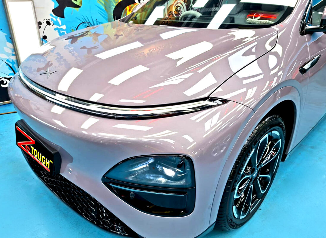 The XPENG G6 Pro's coated paintwork under workshop lighting.