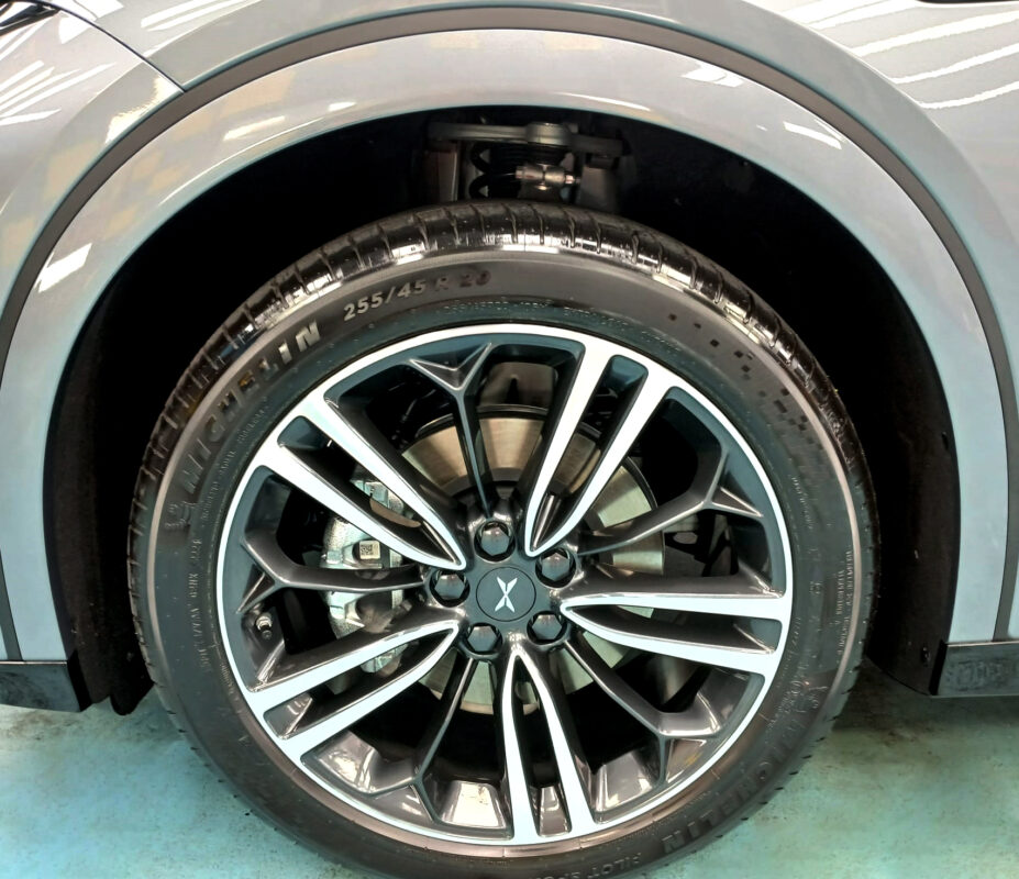 Coated bonnet of the XPeng G6 RWD under workshop lighting.