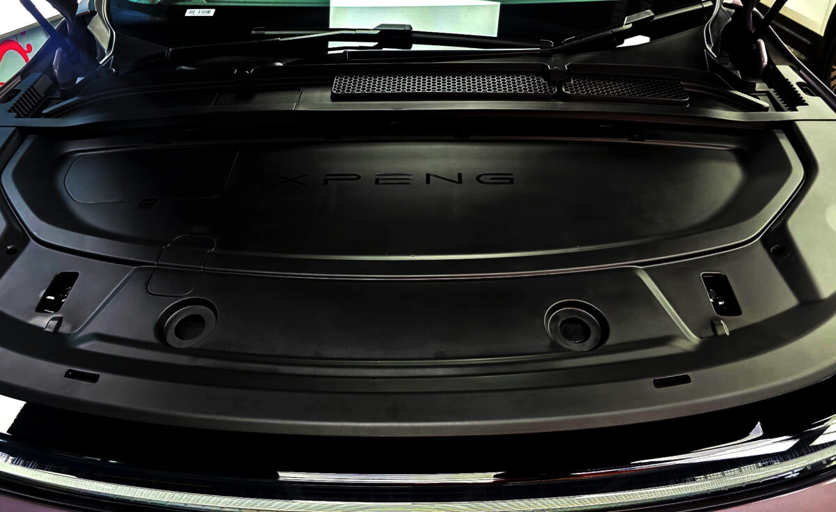 Reflections across the coated panels of the XPENG G6.