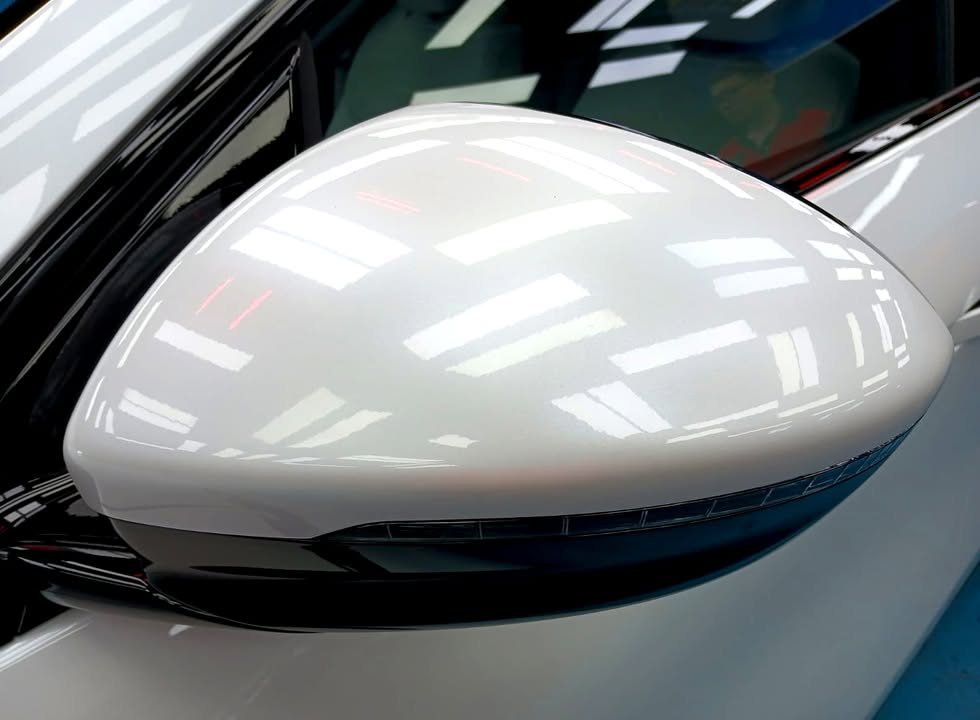 White side mirror cap with a glossy reflection.