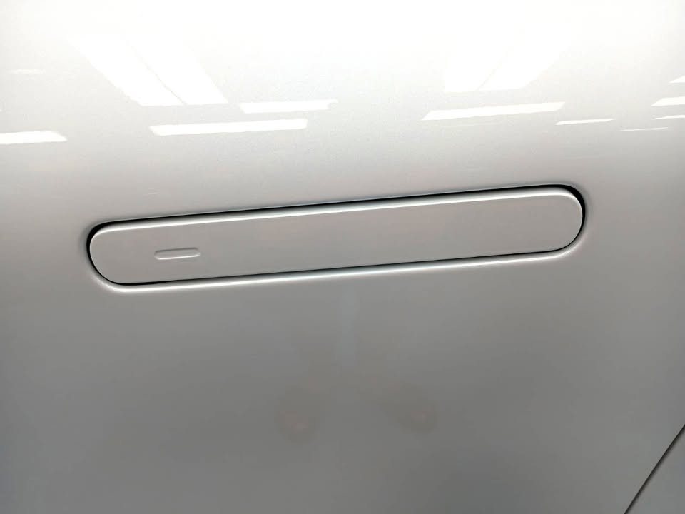 White door panel with a flush door handle.