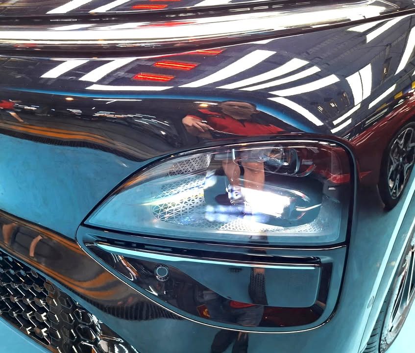 Close-up of the headlight cluster set in glossy black paint.