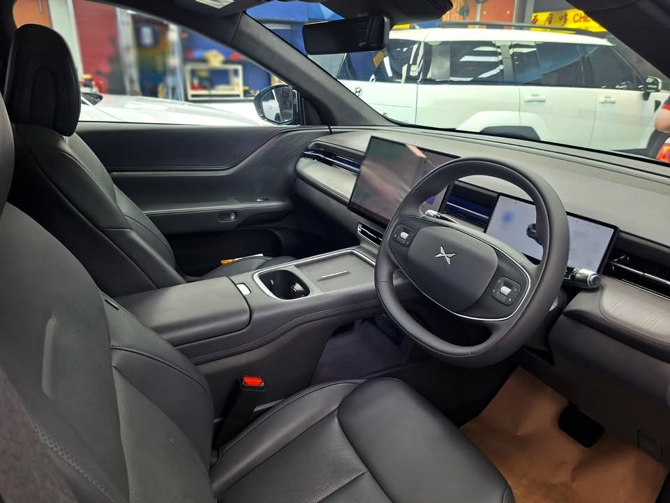 Xpeng G6 front cabin with dark seats and the centre screen.