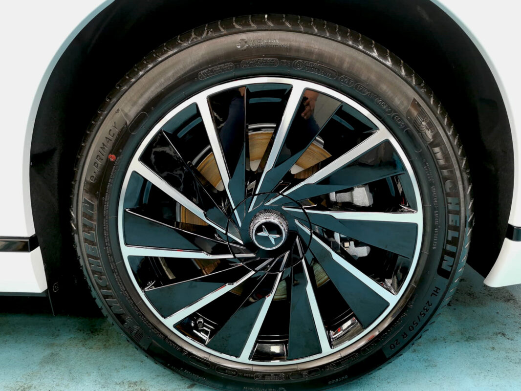 The coated bonnet of the XPeng G9 under workshop lighting.