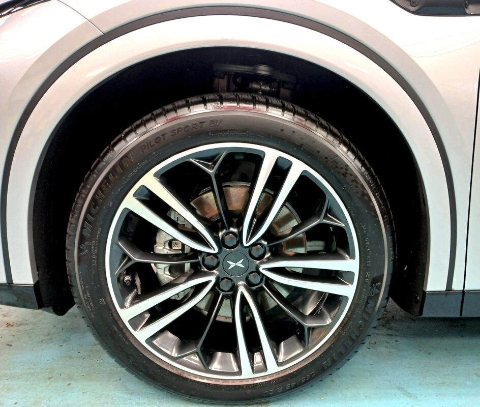 Rear quarter of the XPeng, glossy and protected.