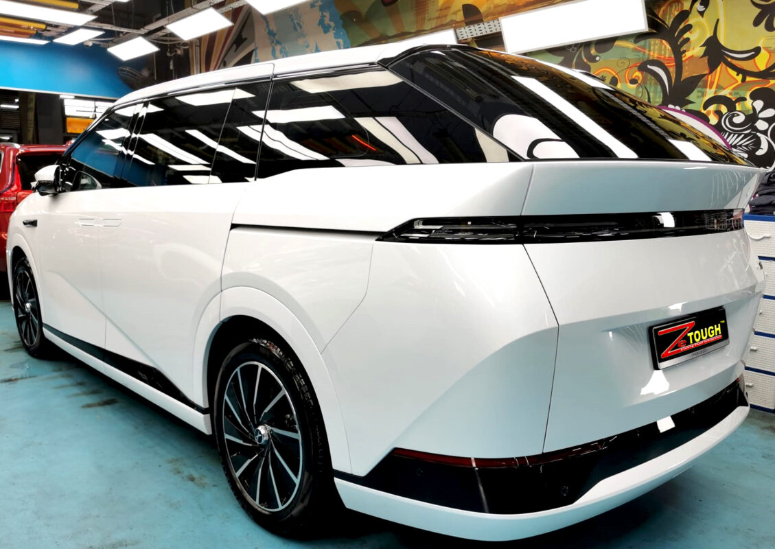 Close-up panel showing the deep ceramic shine on the XPeng X9.