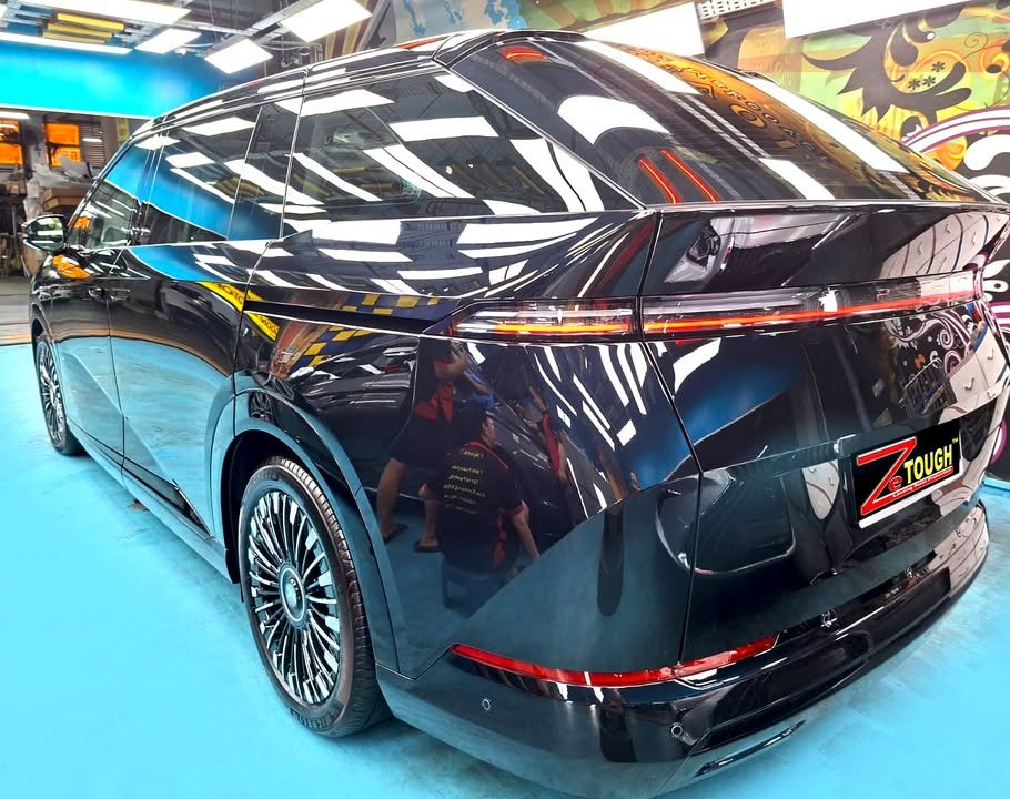 Rear three-quarter view of the XPeng X9 showing the full-width tail light.