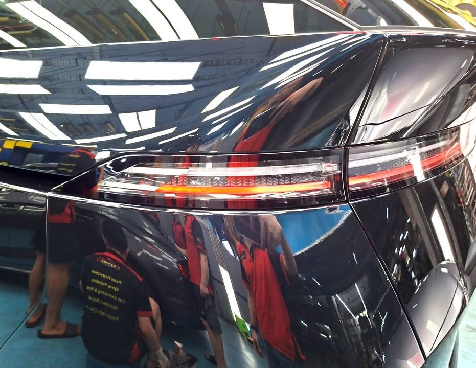 Close-up of the X9 tail light bar and glossy rear panel.
