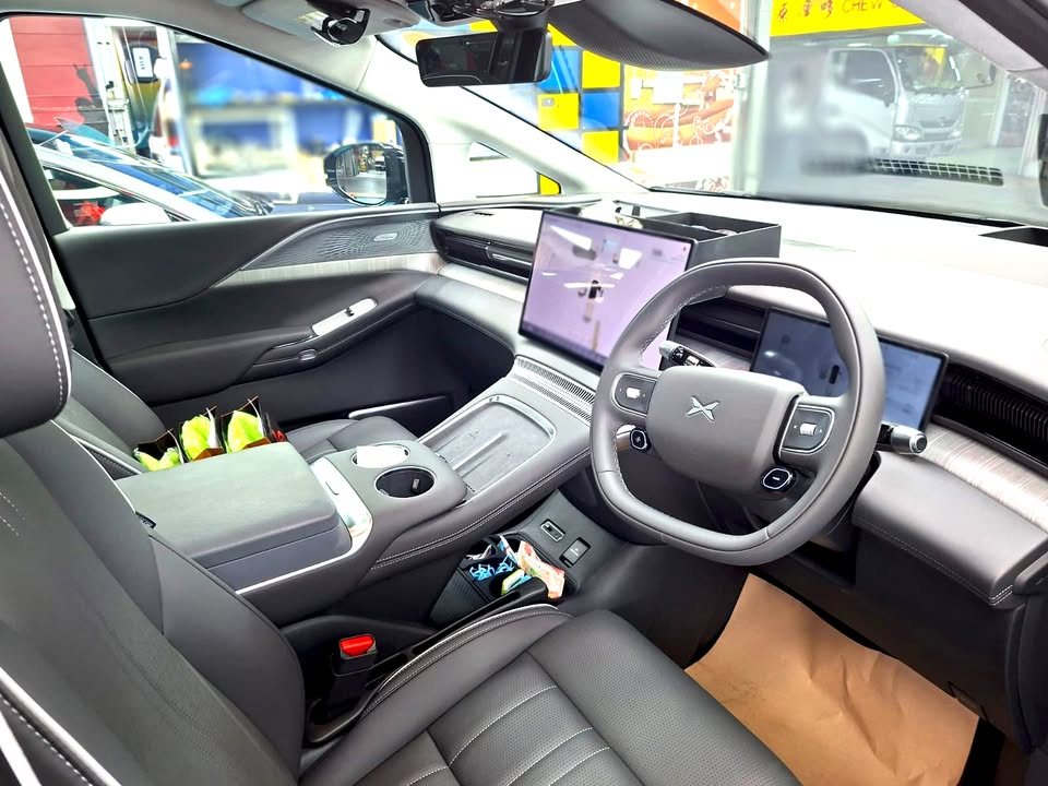 X9 cabin with grey seats, steering wheel and twin screens.