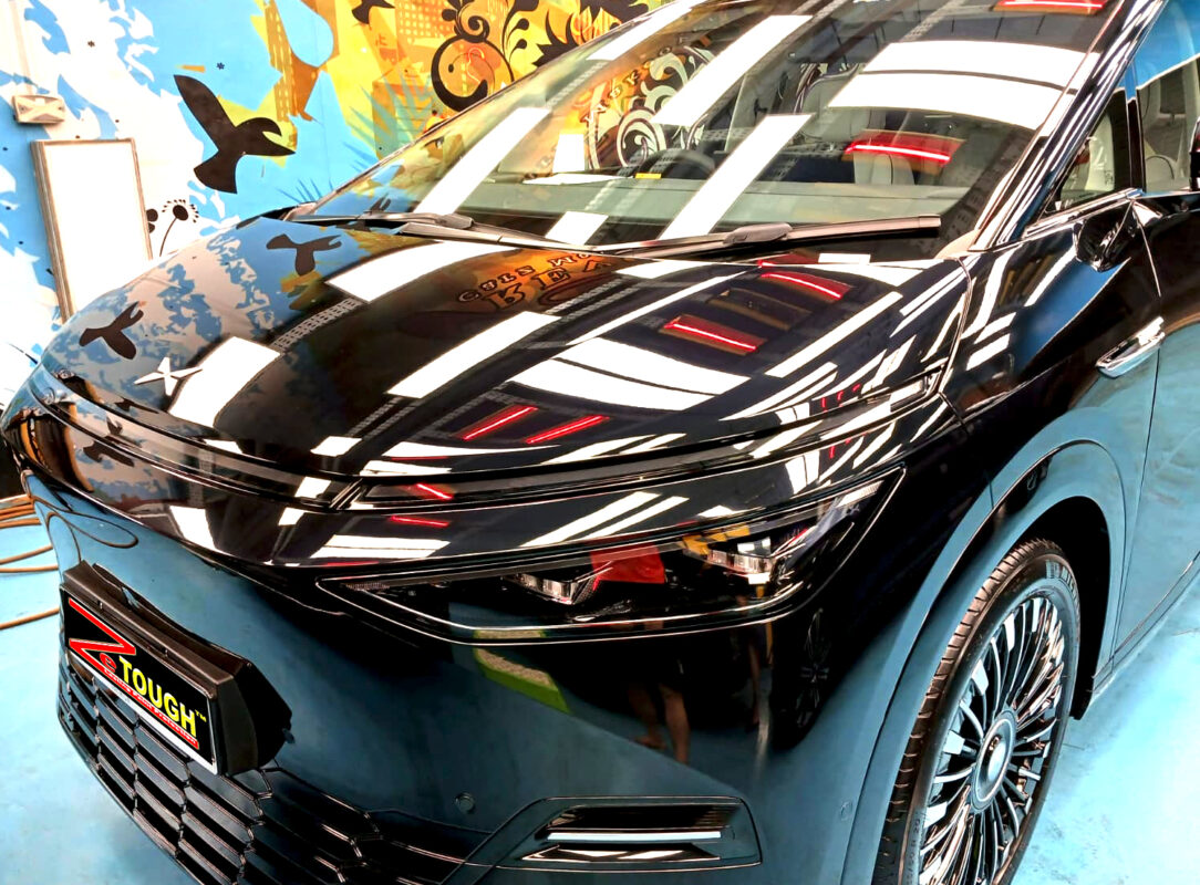 The XPENG X9's coated paintwork under workshop lighting.
